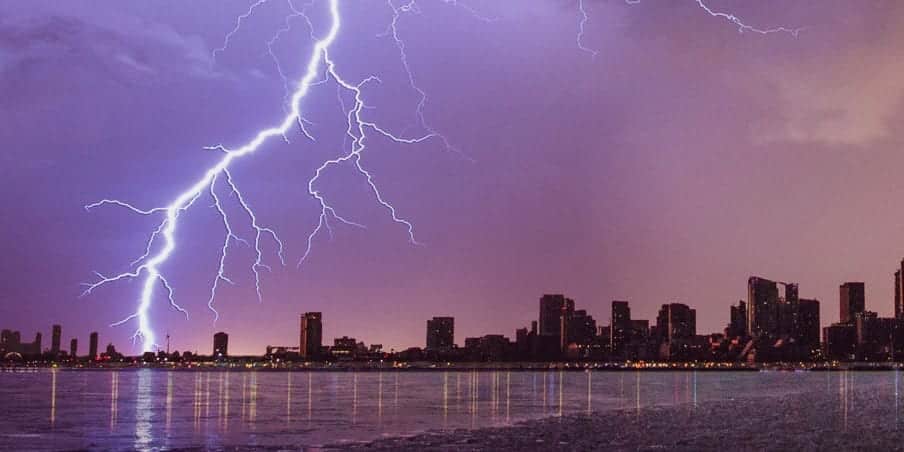 A photo of lightning striking commercial buildings.