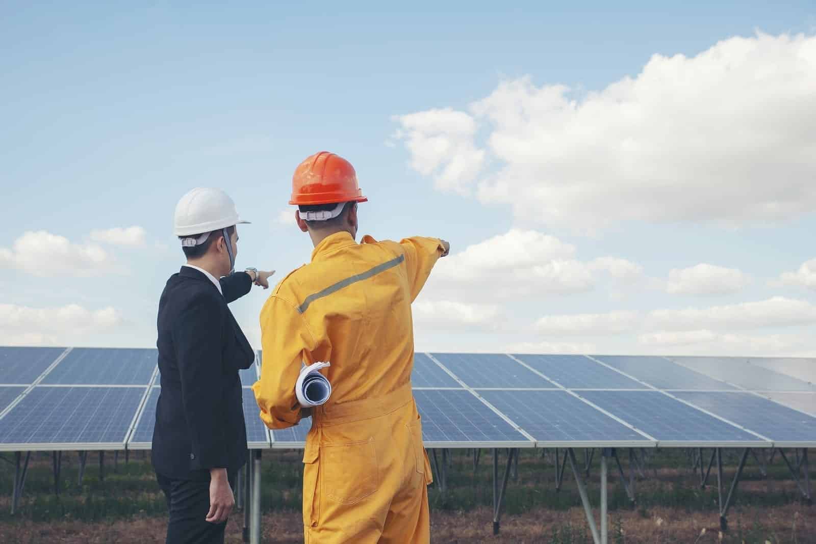 Contractors discussing solar panel lightning protection.